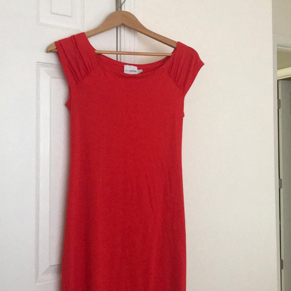 Orange fitted bodycon dress with open back.